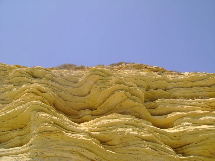 the view of a dune with wavy rock formations