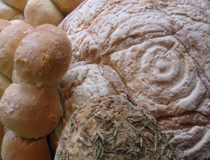 some rolls sitting on top of one another covered in powdered sugar