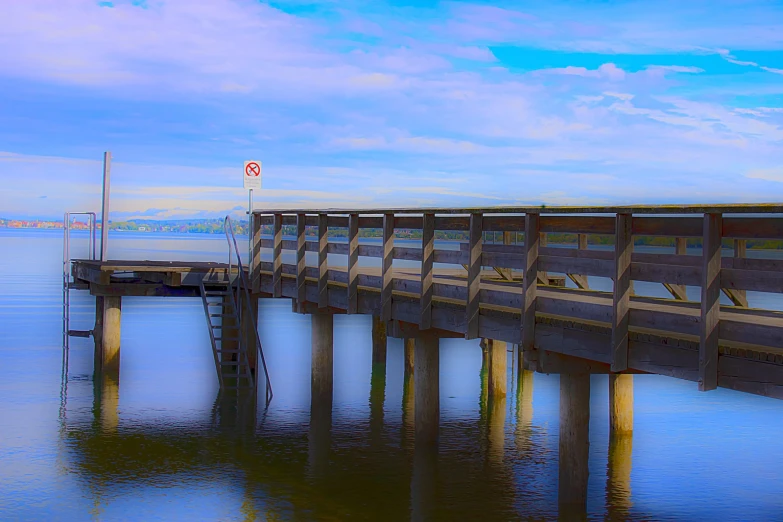 a wooden pier sits in the middle of the water