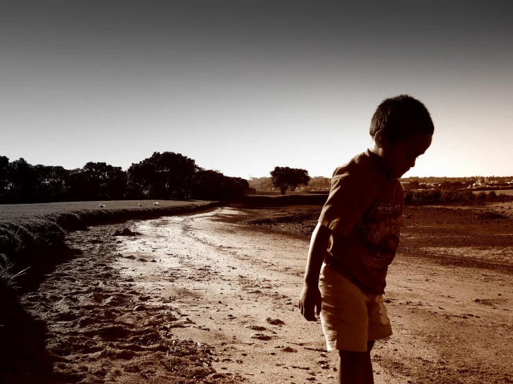 a  playing frisbee on a dirt road