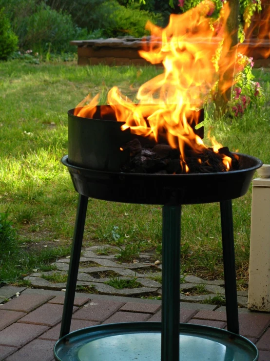 an outdoor fire pit with bright orange flames