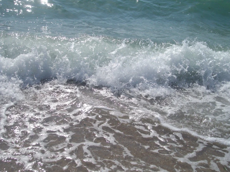 a view of the ocean with waves crashing on the beach