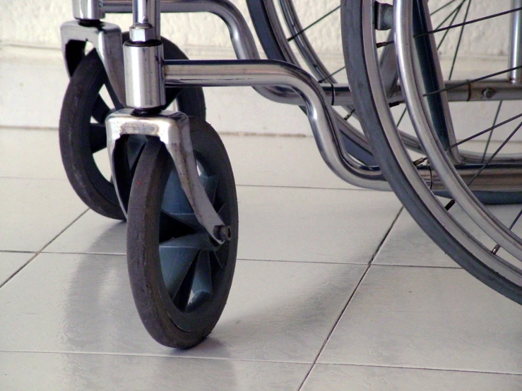 the wheel of a wheelchair on the tiled floor