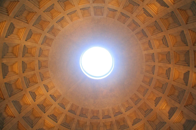 looking up at a circular window inside the dome of a church