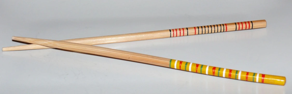 two wooden mallets with different colored stripes on them