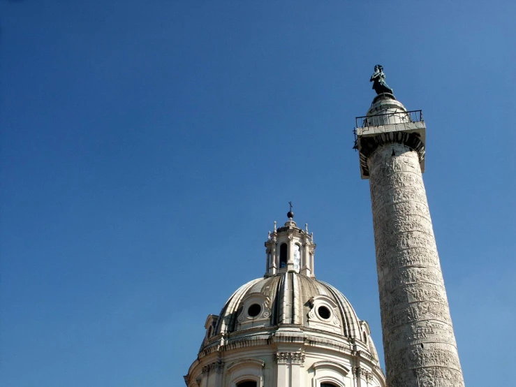 a tower with an obelisk is in the foreground