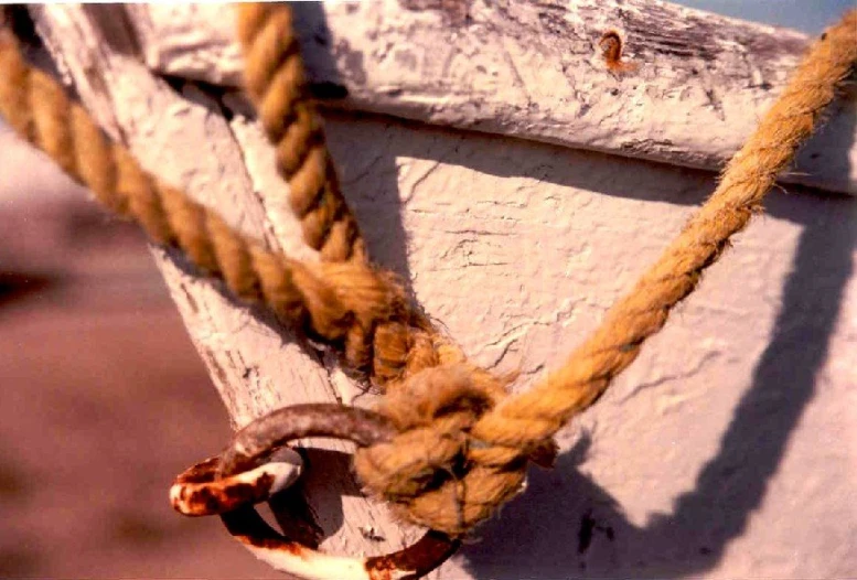 rope attached to boat in the water on cloudy day