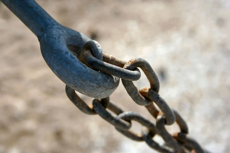 a large metal chain is in the middle of the ground