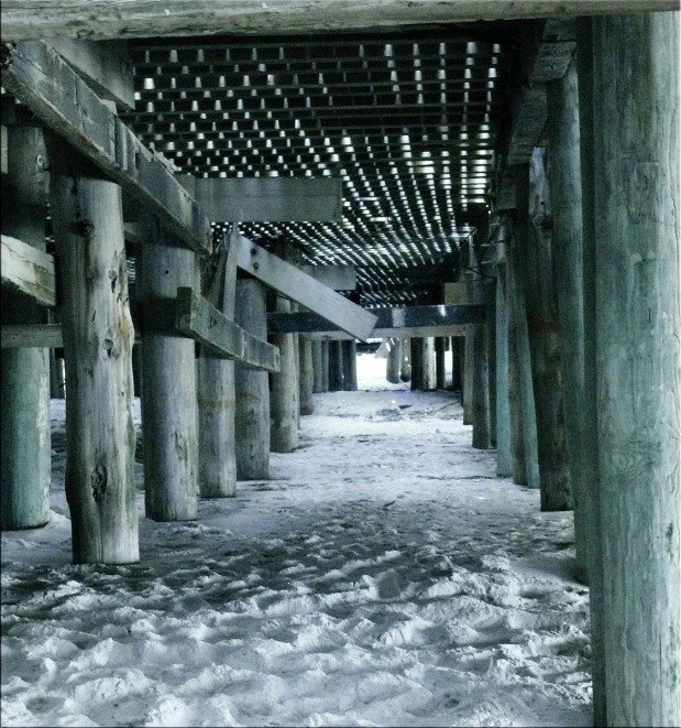 a long and narrow snowy walkway that leads to the beach