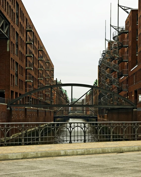 a row of buildings stand near an arched bridge