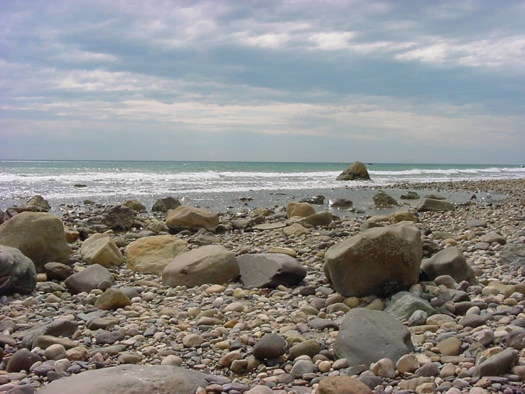 rocks on the beach and waves in the background