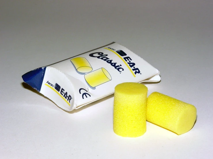 two yellow toothpaste pieces and one white tube