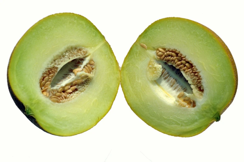 an open whole green vegetable with some sort of seeds inside