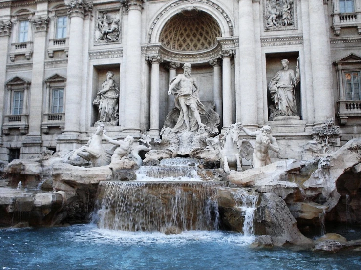 a fountain is located in front of an old building