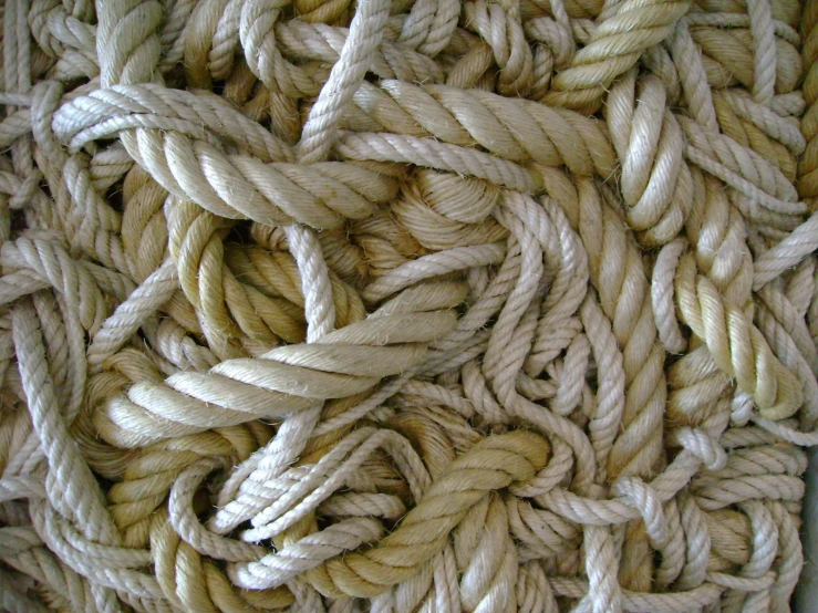 many knots of white rope laying on top of each other