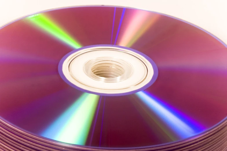 there is a stack of multicolored cd's in the image