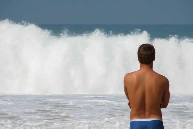 a man looking at an ocean wave with  on