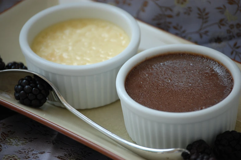 a close up of two bowls of food on a plate