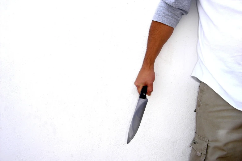 a person holding a knife with a hand on it