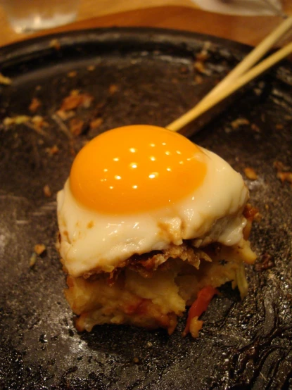 a breakfast plate is shown, with an egg on top