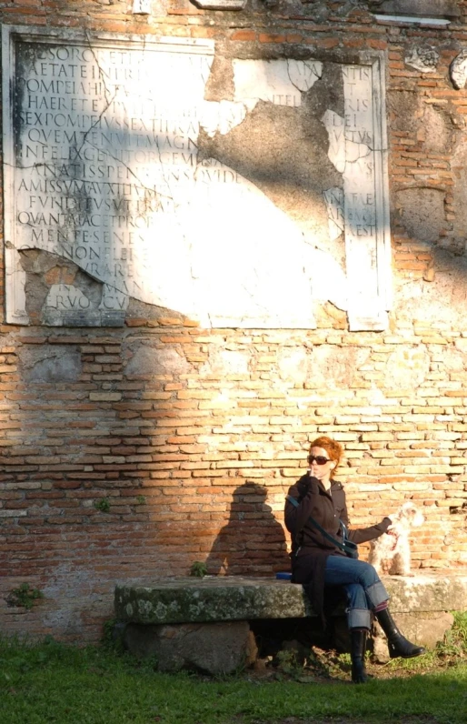 a woman sitting on a bench with her dog