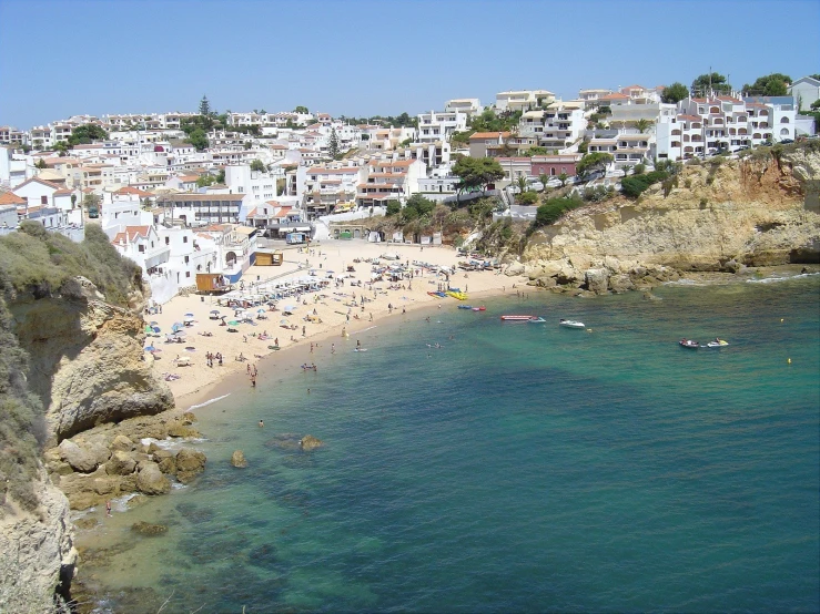 a view of an overview beach with people on the shore and in the water