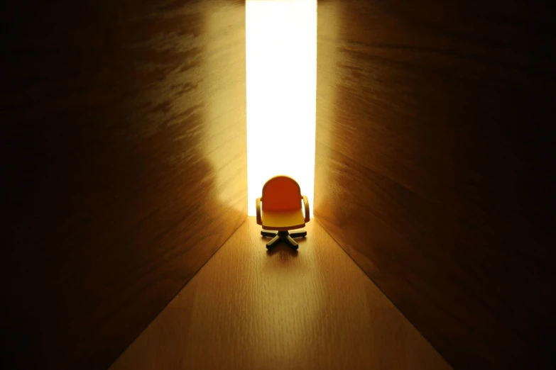 small chair in a small room lit up by light