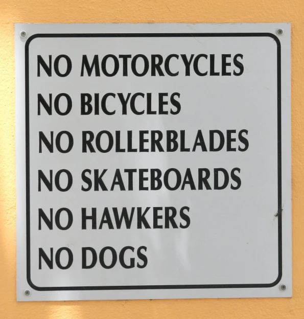 a sign that says no motorcycles and rides on boards