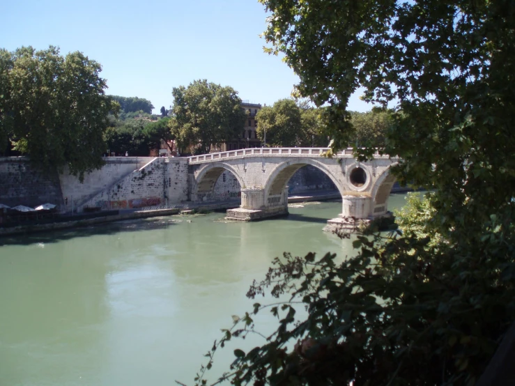 an arched bridge crossing the width of water