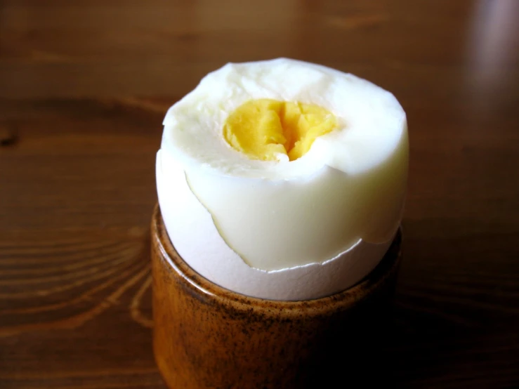 boiled egg in wooden container sitting on table