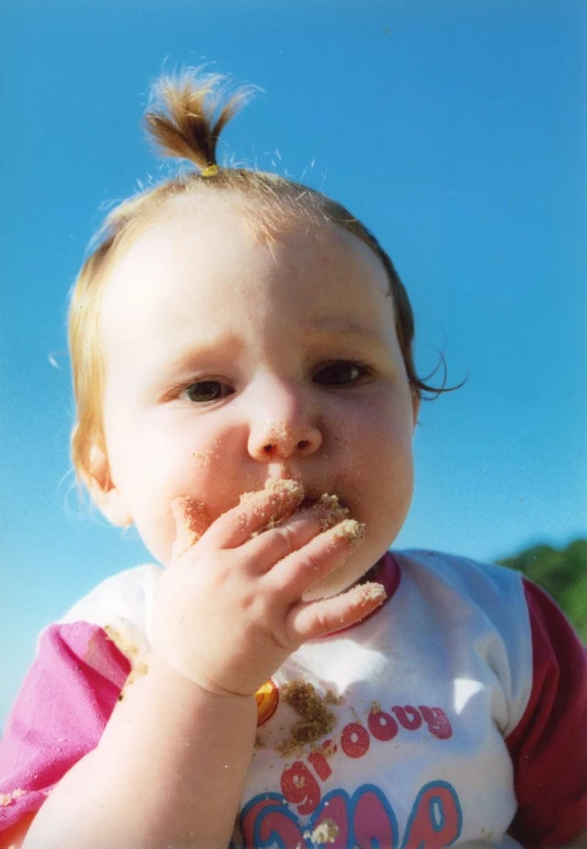 a  eating food while sitting on the ground