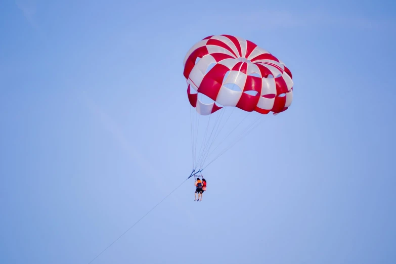 a person who is parasailing high up in the sky