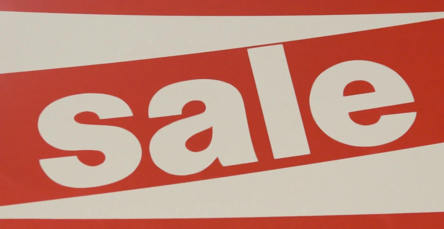 a red and white sale sign with the word sale on it