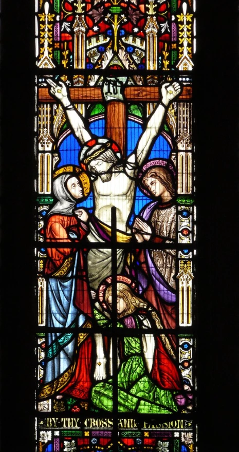 a stained glass window depicting jesus on the cross