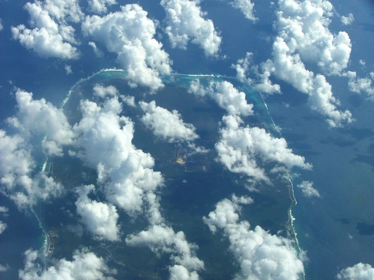 a group of clouds float in the shape of a shape in a circle