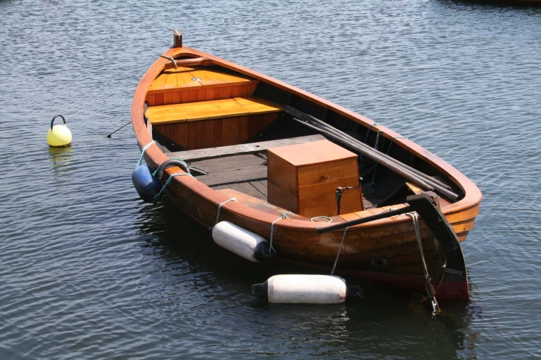 a small boat is floating on the water near the dock