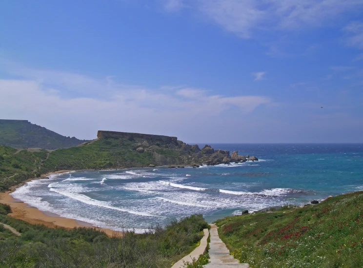 a path leads along the shore towards an island