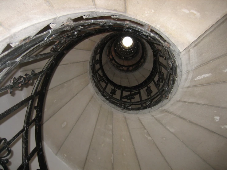 there is a very tall spiral staircase with railings