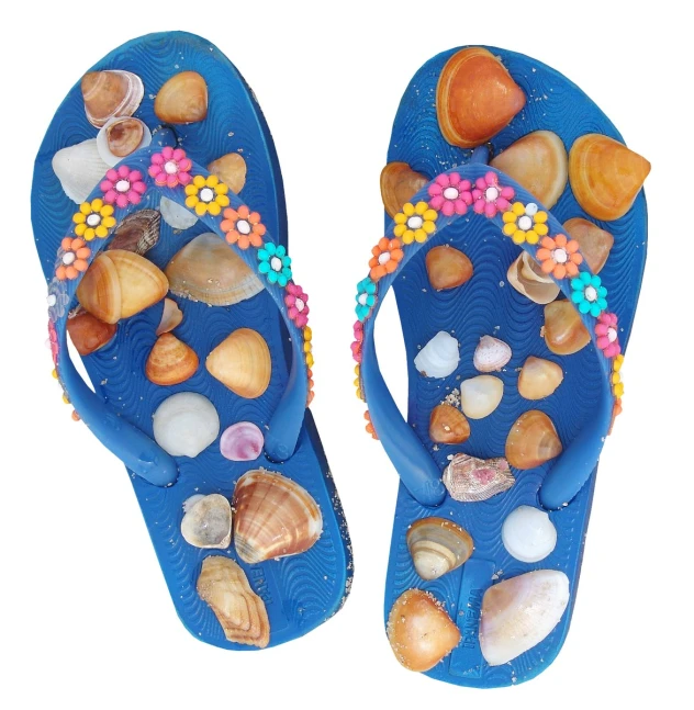 a pair of blue flip flops decorated with shells