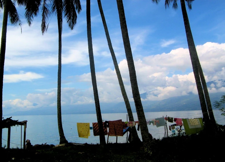 several colorful laundry hung to dry on the clothes line by the beach