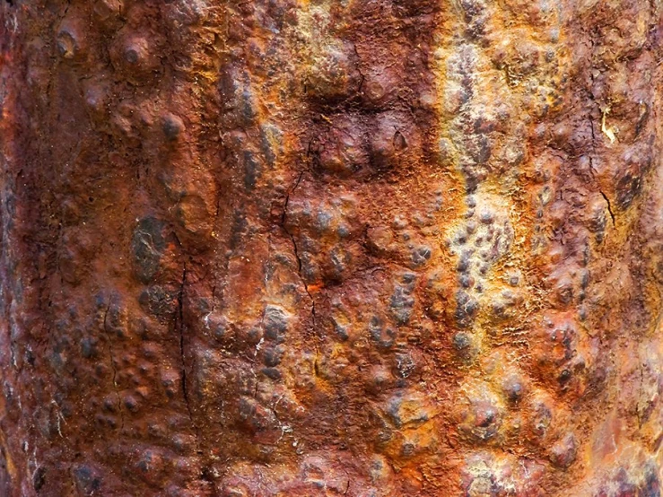 an orange metal column that has some rust on it