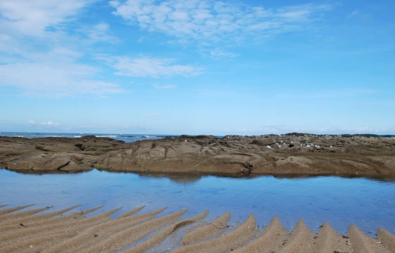 sand covering water and the beach with an ocean view