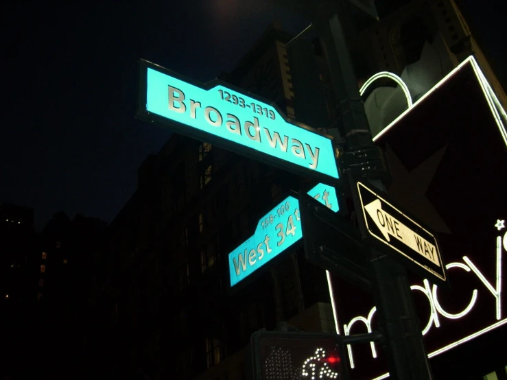 two street signs mounted to the side of a light pole