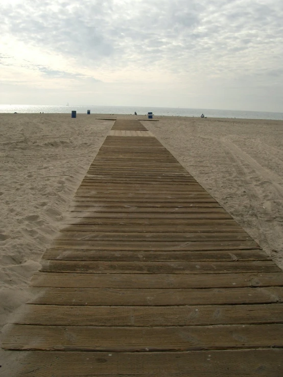 a pathway to the beach is made of wooden planks