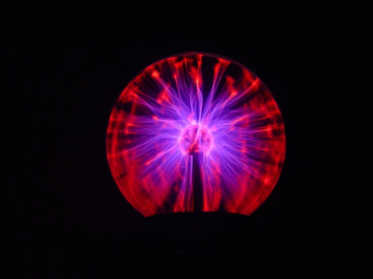 a large purple wheel in the dark