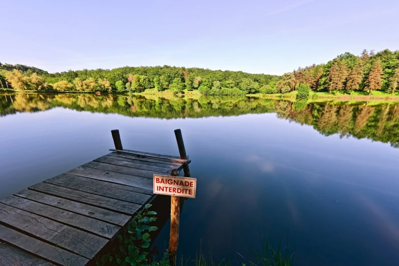 a wooden dock sitting on the shore of a lake