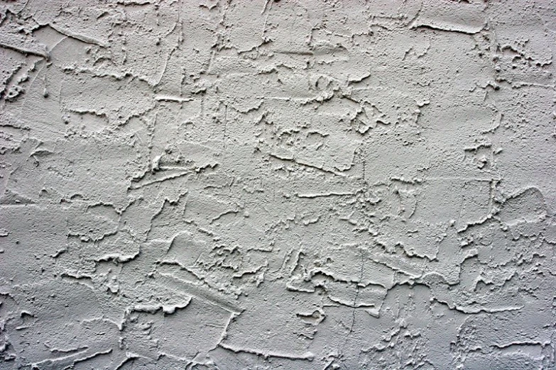 an old, grungy cement wall with some light stains