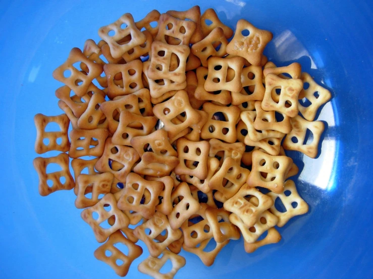 a large bowl filled with cookies and cookies cut in shapes