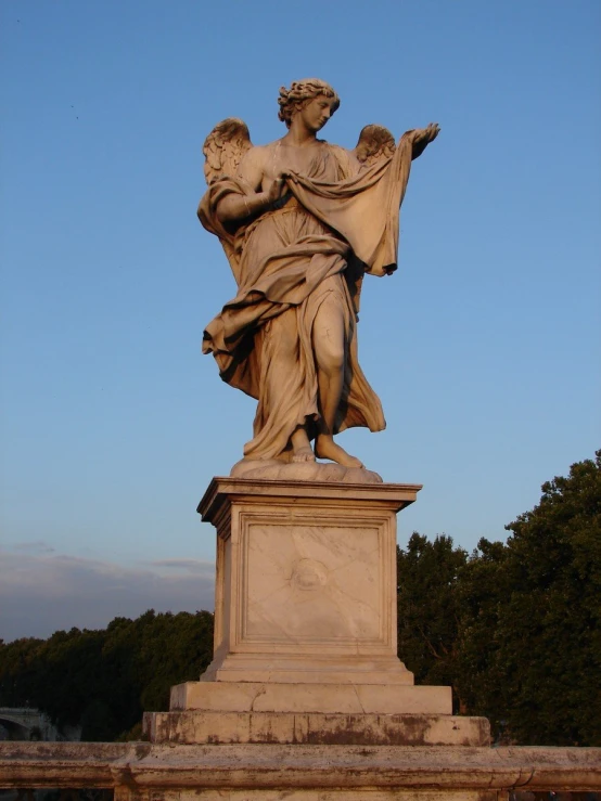 a statue of an angel holding a flag