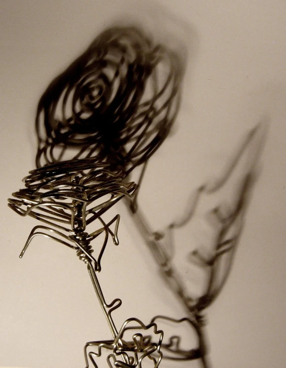 a black and white po of a sculpture with a single flower